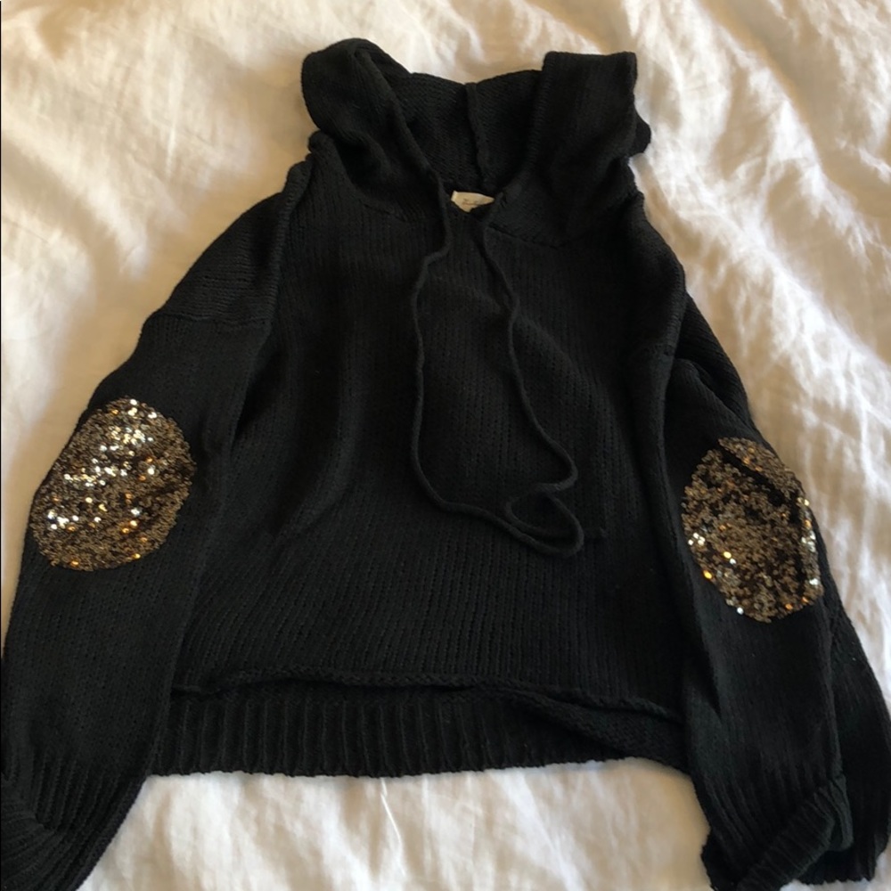 Black hoodie with gold elbow patches